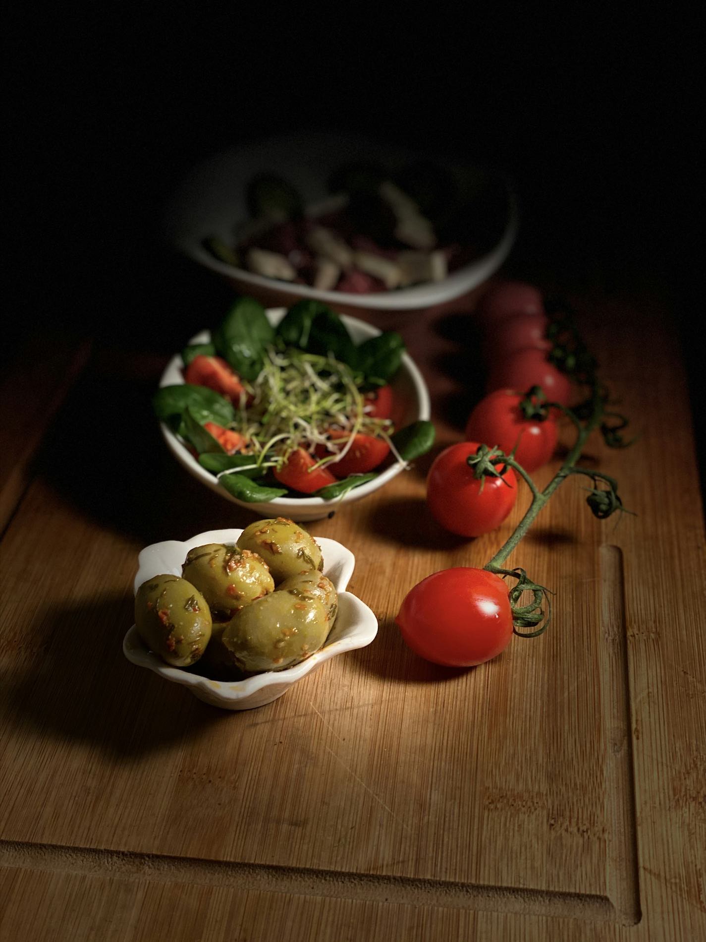Bowls of roasted vegetables on a dark table